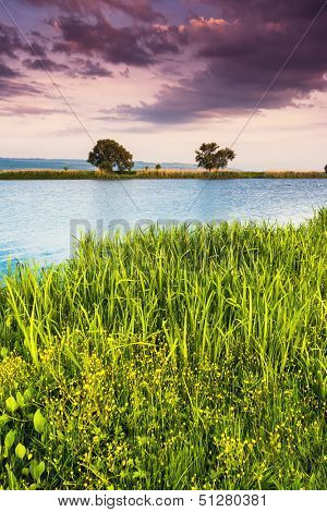 Beautiful view of sinuous river in summer. Dramatic overcast sky. Southern Buh River, Ukraine, Europe. Beauty world.