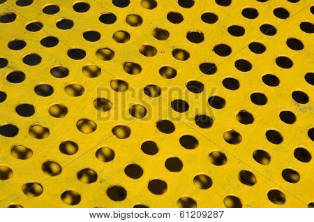 Yellow metal sufrace with holes