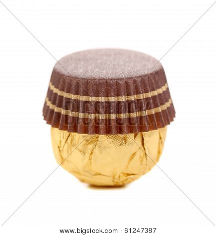 Chocolate gold bonbon with nuts.
