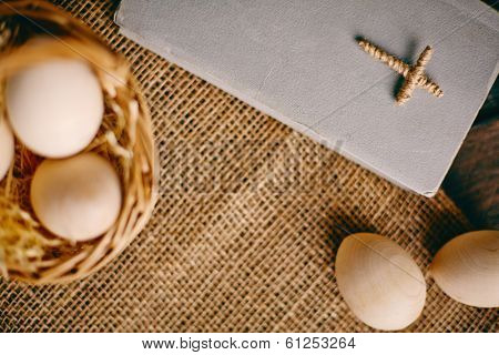 Image of the Holy Bible with wooden Easter eggs near by