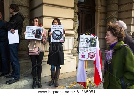 KRAKOW, POLAND - MAR 9, 2014: Unidentified participants during protest near Cracow Opera, against bringing Russian troops in the Crimea. Posters: Ukraine without Putin, and Putin - Thief.