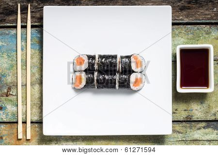 Makisushi On White Plate. Seafood Traditional Maki Sushi Rolls With Chopsticks