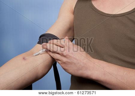 Drug addict man with syringe in action