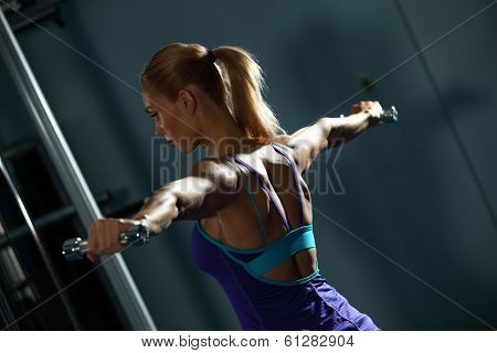 Image of fitness girl in gym exercising with dumbbells
