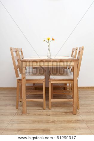 Dinning table and chairs  in empty  room.