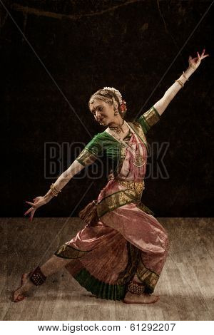 Vintage retro style image of young beautiful woman dancer exponent of Indian classical dance Bharatanatyam