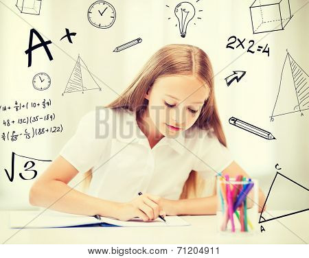 education and school concept - little student girl drawing at school