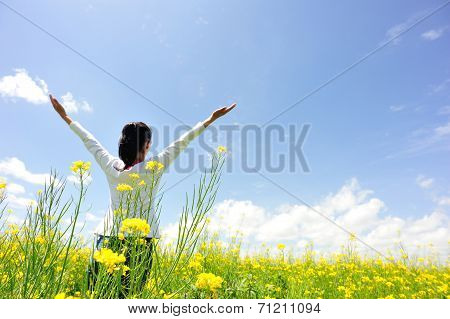cheering woman open arms at cole flower field
