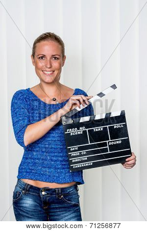 a woman holds a typical clapper in her hand