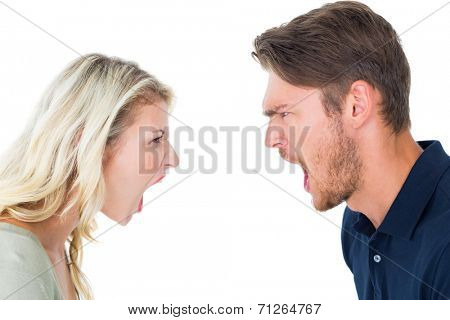 Angry couple shouting during argument on white background