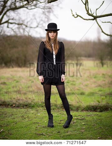 Beautiful Young Woman Dressed In Black Wearing Bowler Hat