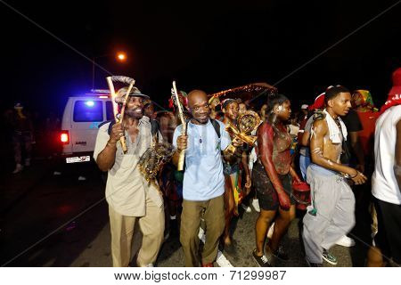 Men hefting Caribbean tamborines