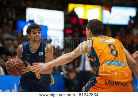 VALENCIA, SPAIN - JANUARY 24: Neto with ball and Nedovic during Spanish League match between Valencia Basket Club and UCAM Murcia at Fonteta Stadium on January 24, 2015 in Valencia, Spain