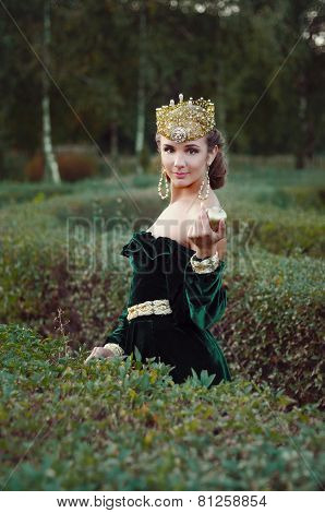 Elegant Young Woman Dressed Like Queen Walking In Garden