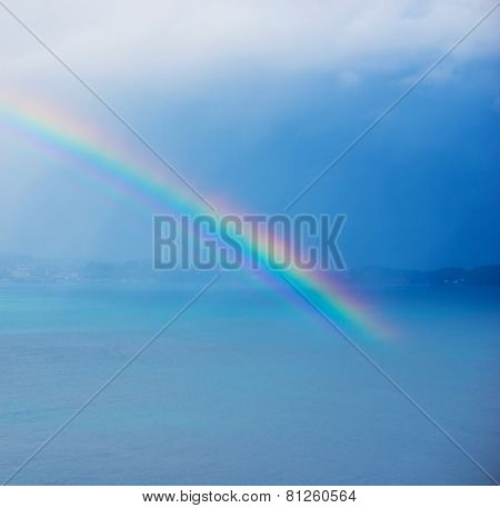 Beautiful rainbow over bay or ocean. 