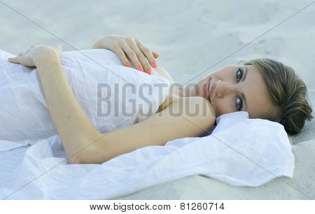 Young woman lying on the sand