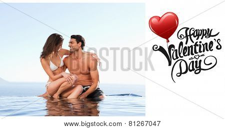 Couple sitting on pool edge together against cute valentines message