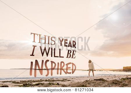 Woman in sweater walking on beach against i will be inspired