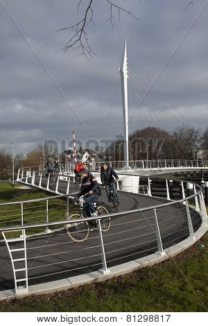 Cycling on the bridge, people crossing the river in rijswijk holland