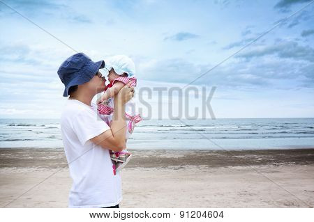 Father and daughter playing at the beach