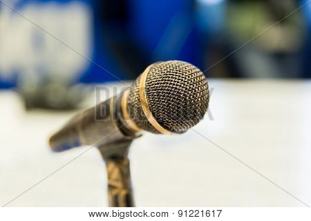 technology, electronics and audio equipment concept - close up of microphone at recording studio or radio station
