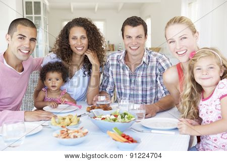 Families Enjoying Meal Together At Home