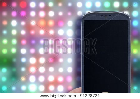 Smatrphone and disco background. Idea for party app, digital detox, taking shots, accessing apps, Internet, blogs and others. The background image is an illustration created by the same author.