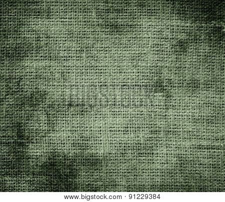 Grunge background of camouflage green burlap texture