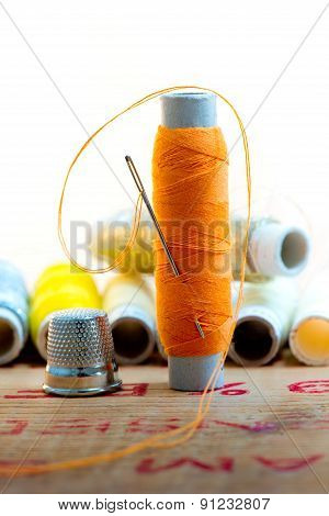 Nedle With Orange Color Thread