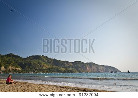 Unidentified tourists enoying Puerto Lopez beach, popular vacation spot in the coast of Ecuador