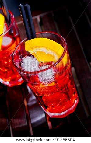Spritz Aperitif Aperol Cocktail With Orange Slices And Ice Cubes On Color Disco Light Background
