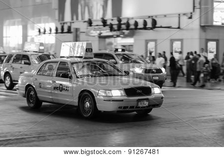 NEW YORK - SEPTEMBER 28, 2011: yellow cabs at area near Times Square at night. Times Square is a major commercial intersection and a neighborhood in Midtown Manhattan, New York City