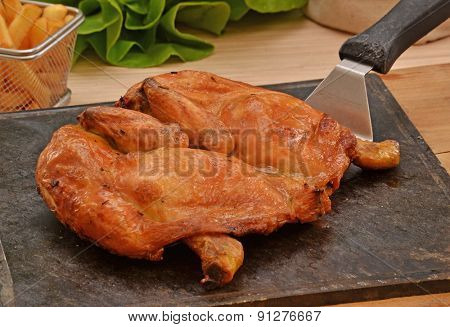 Grilled chicken on hot grill stone.