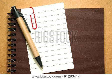 Note Paper Clip On Notebook With Pen