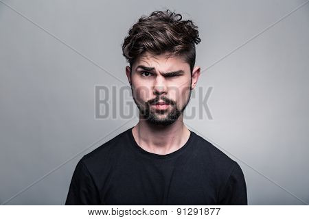 Young handsome man doubting isolated over gray