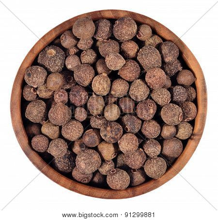 Allspice In A Wooden Bowl On A White