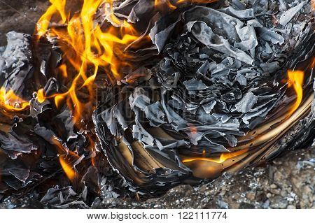 Burning office white paper in bonfire outside