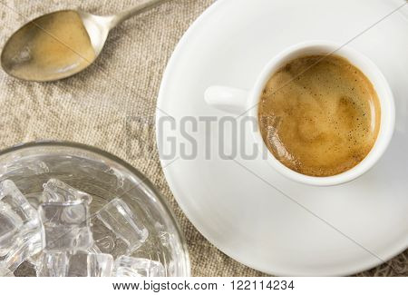 Espresso with ice cold water on wooden table