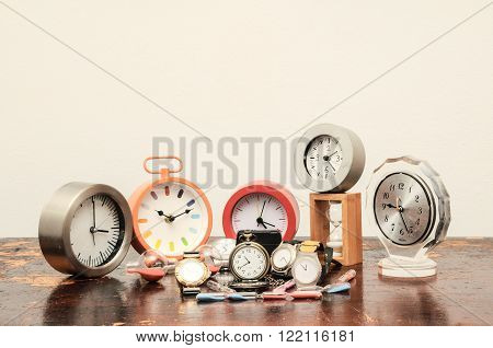Many Different Clocks on a Woden Table