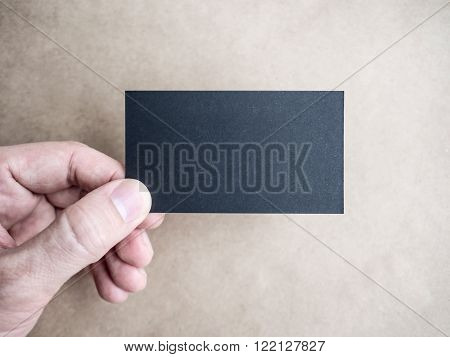 Closeup of hand holding black business card Mockup