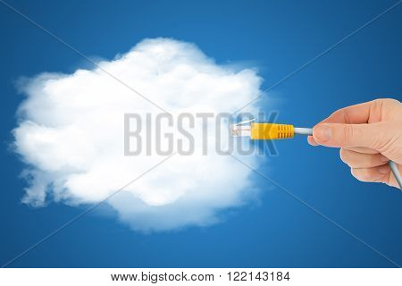 Hand holding computer cabel with cloud in sky, technology concept