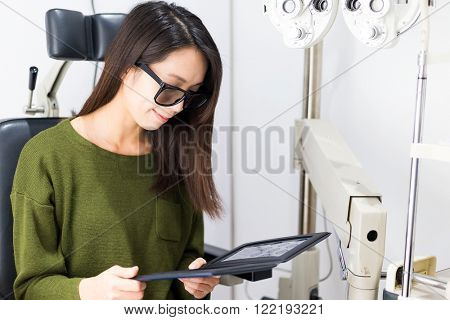 Woman checking sense of three dimensional on eye clinic