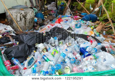 KO MOOK ISLAND, THAILAND, JANUARY 07, 2016 : Heap of soda and water plastic bottle, stored before burning or recycling, Ko Mook island, Thailand