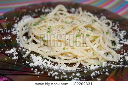 Spaghetti pasta with parmesan and herbs on a plate