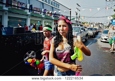 KO SAMUI, THAILAND - APRIL 13: Unidentified girl in a water fight festival or Songkran Festival (Thai New Year) on April 13, 2014 in Chaweng Main Road, Ko Samui island, Thailand.