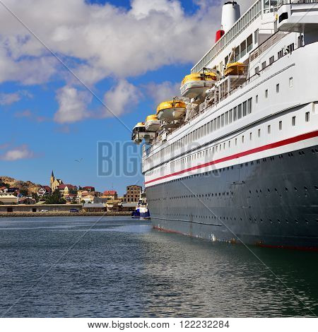 LUDERITZ NAMIBIA - JAN 27 2016: Big cruise ship shown in the port of Luderitz in the early morning. Luderitz is popular destination a many of cruise lines