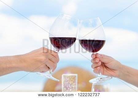 Couple drinking wine in romantic dinner on twighlight closeup. Selective focus shallow depth of field