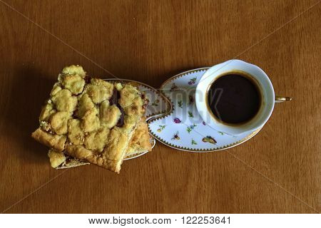 cup of coffee and pie with jam