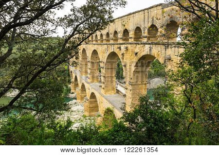 Pont du Gard in Provence France over the Gardon river is an 160 foot high roman aqueduct built to provide water to the city of Nimes from the river Eure near Uzes in the first century A.D.