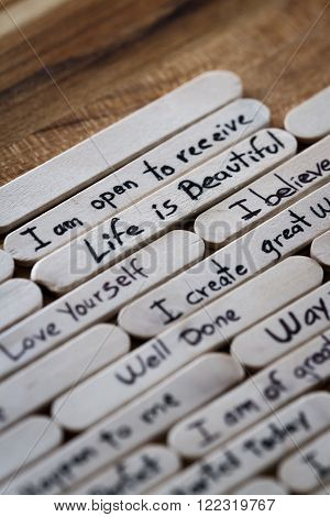 positive thoughts written on lollipop sticks as a concept